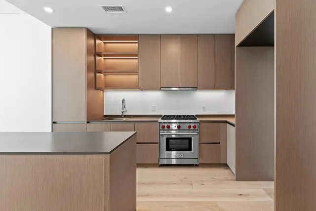 a kitchen with stainless steel appliances granite countertop a sink and a stove