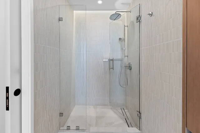 a bathroom with a glass shower door