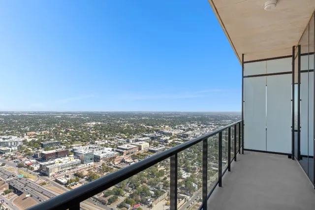 a view of balcony with wooden floor and fence