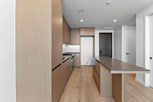 a view of hallway with wooden floor