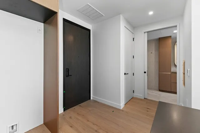 a view of hallway with wooden floor