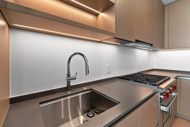 a close view of a sink and cabinets