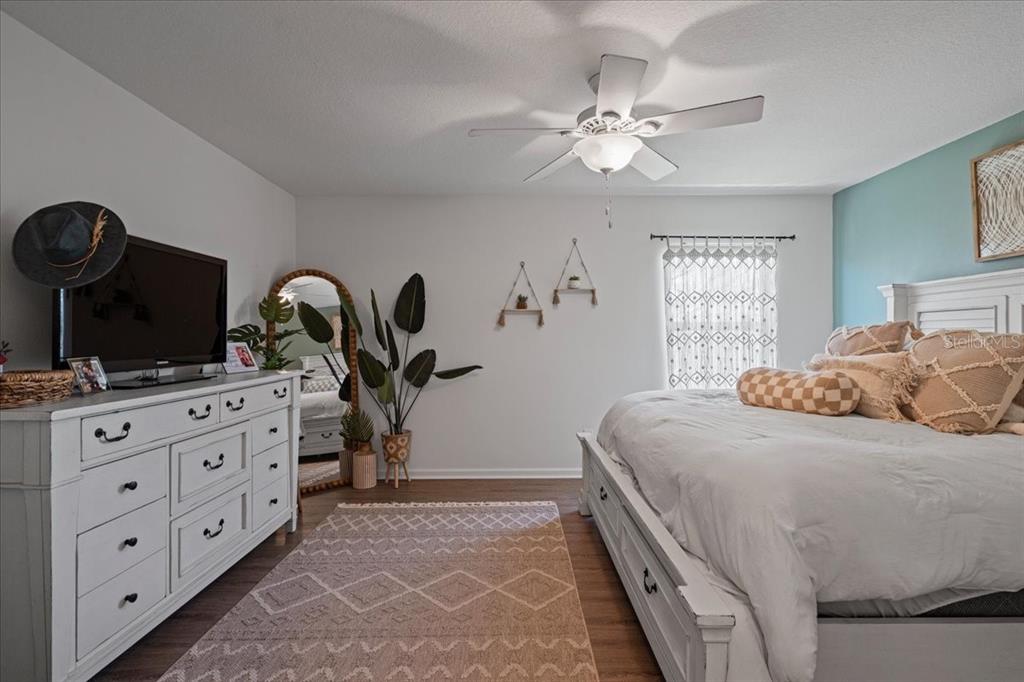 3271 Titanic Circle, Unit 39 Indialantic, FL 32903 - Photo 38 of 60 a bedroom with a large bed and a chandelier
