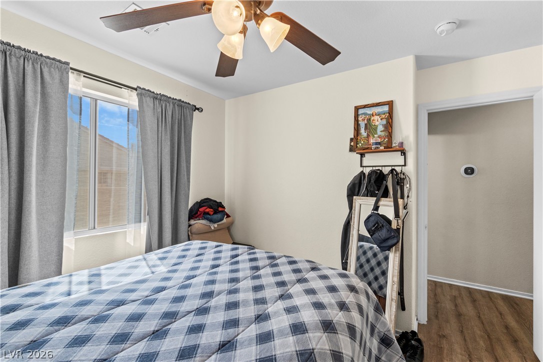 1419 Red Sunset Avenue Henderson, NV 89074 - Photo 29 of 35 Bedroom featuring wood finished floors and a ceiling fan