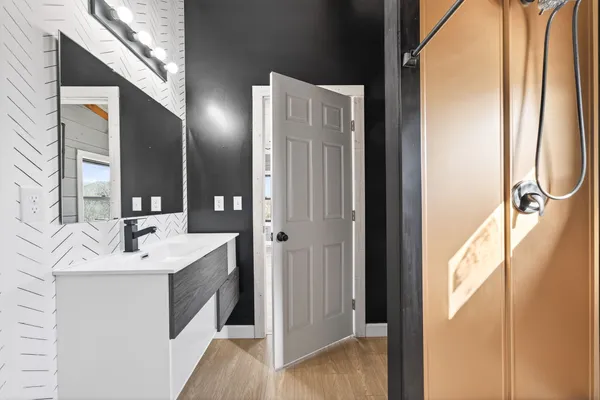 a bathroom with a sink toilet and mirror