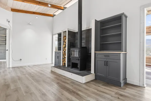 a view of a hallway with wooden floor and entryway