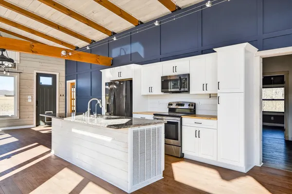 a view of a open kitchen with a large window