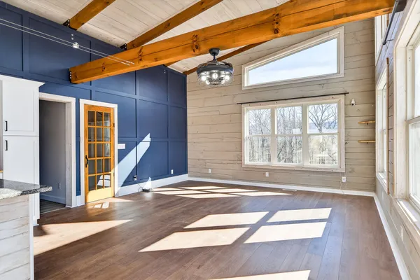 a kitchen with a stove a sink and a wooden floor