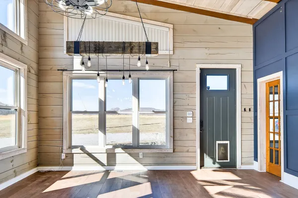 a view of kitchen with stainless steel appliances cabinets and a table