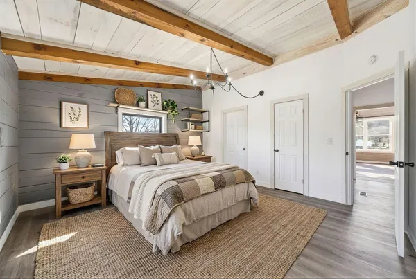 a spacious bedroom with a bed and a table