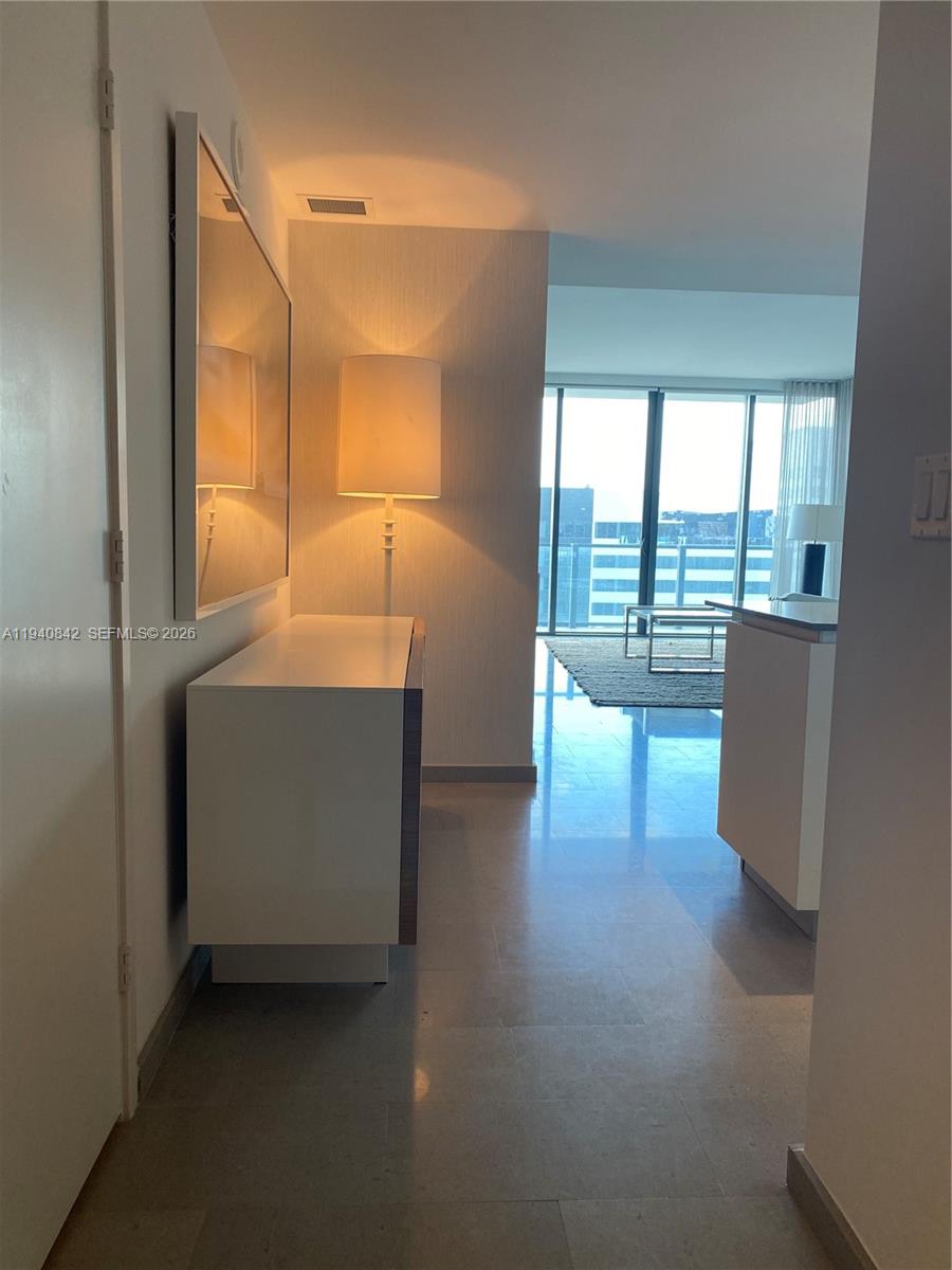 88 Southwest 7th Street, Unit 1904 Miami, FL 33130 - Photo 13 of 33 a view of hallway with furniture and a large window