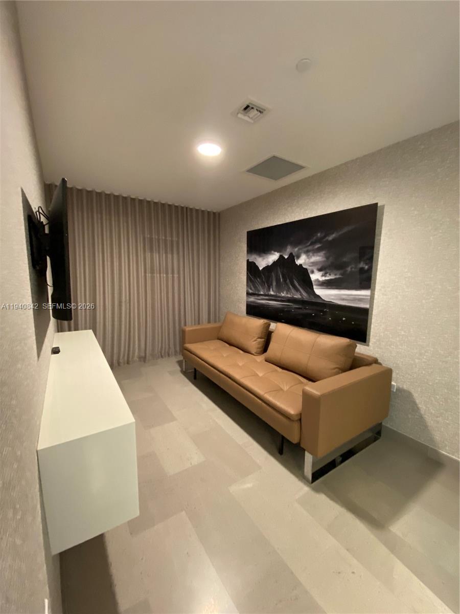 88 Southwest 7th Street, Unit 1904 Miami, FL 33130 - Photo 17 of 33 a living room with furniture and a flat screen tv