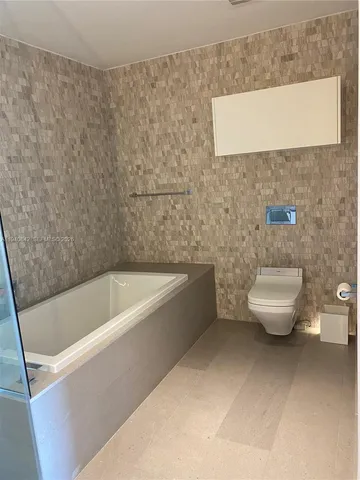 a bathroom with a sink a toilet and bathtub