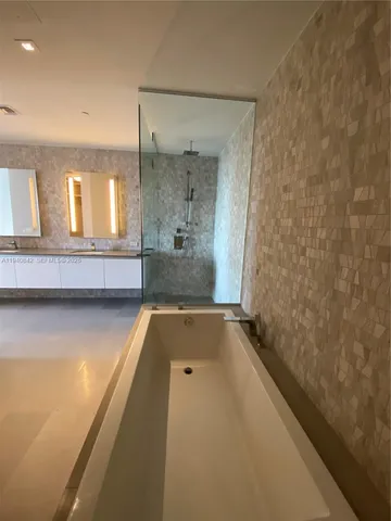 a bathroom with a tub and shower