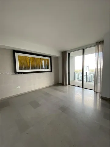a view of a big room with windows and chandelier fan