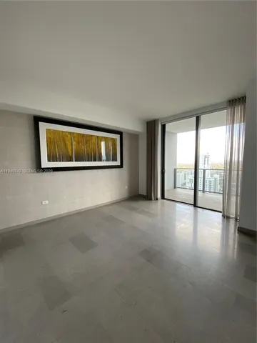 a view of a big room with windows and chandelier fan
