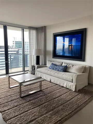 a spacious bedroom with a large bed and a large window