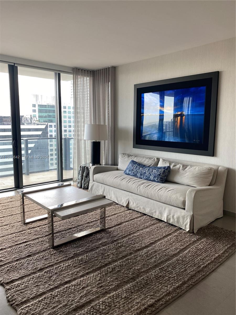 88 Southwest 7th Street, Unit 1904 Miami, FL 33130 - Photo 10 of 33 a spacious bedroom with a large bed and a large window