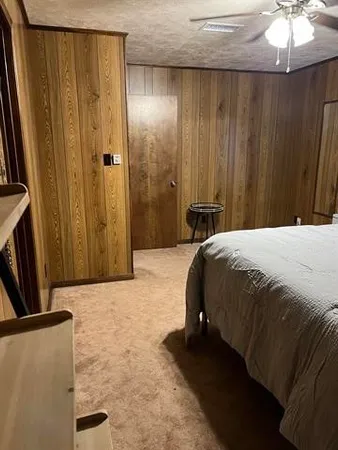 a bedroom with a bed and a mirror