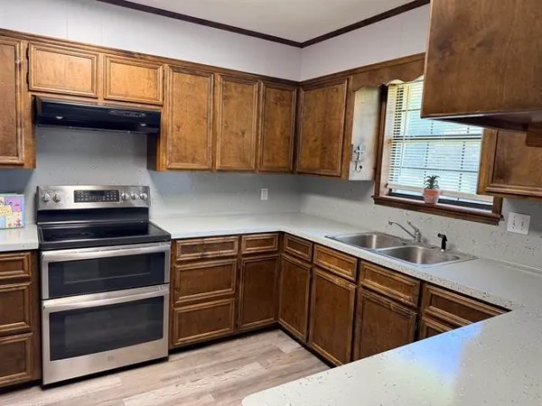 a kitchen with a sink stove and microwave