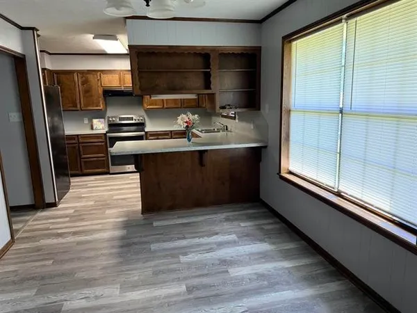 a kitchen with stainless steel appliances a large counter top stove and refrigerator