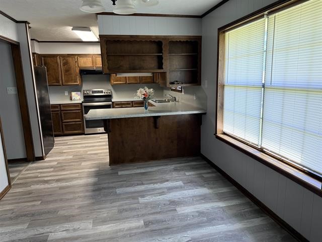 8957 Tejas Lane Silsbee, TX 77656 - Photo 20 of 50 a kitchen with stainless steel appliances a large counter top stove and refrigerator