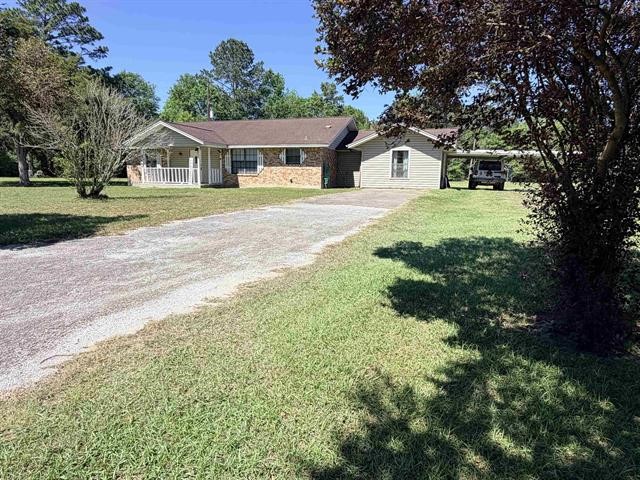 8957 Tejas Lane Silsbee, TX 77656 - Photo 2 of 50 a house view with a garden space