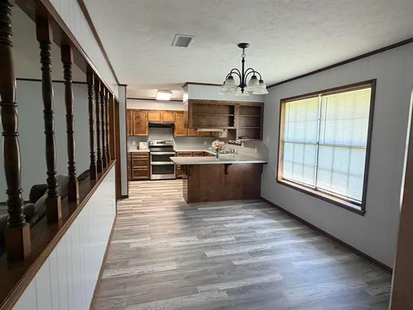 a view of kitchen with sink microwave refrigerator and stove
