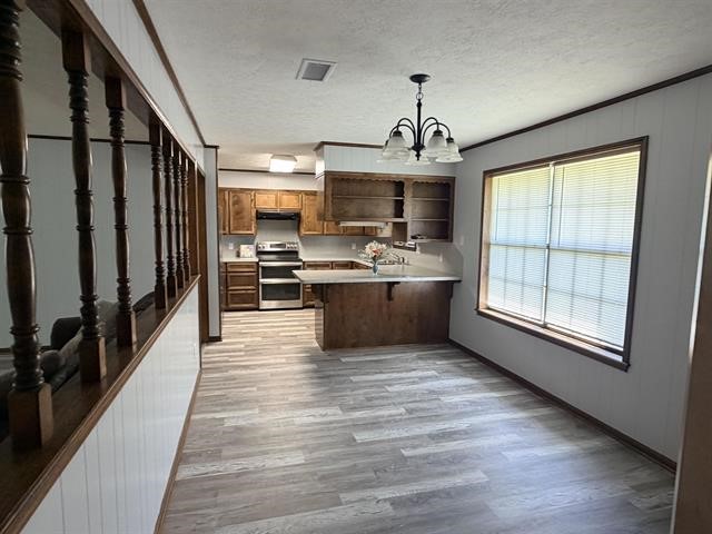 8957 Tejas Lane Silsbee, TX 77656 - Photo 21 of 50 a view of kitchen with sink microwave refrigerator and stove