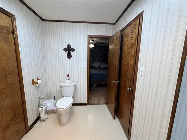 a bathroom with a toilet and a shower