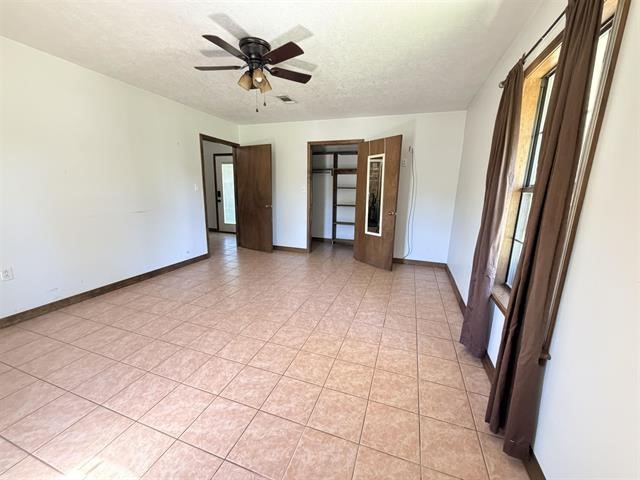 8957 Tejas Lane Silsbee, TX 77656 - Photo 32 of 50 a view of a hallway with a chandelier