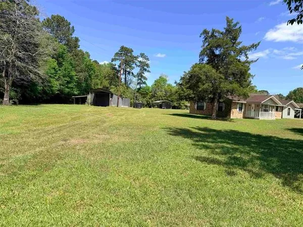a view of a big yard with a house