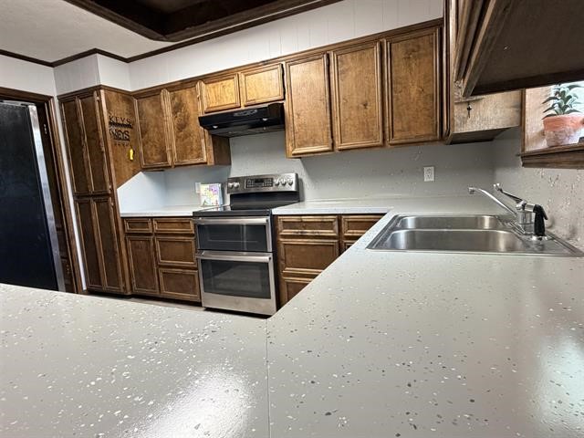 8957 Tejas Lane Silsbee, TX 77656 - Photo 6 of 50 a kitchen with stainless steel appliances a stove a microwave a sink and cabinets
