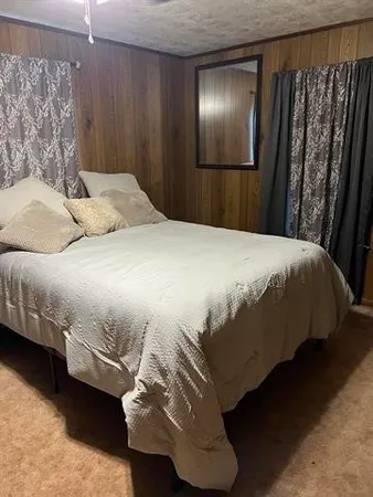 a bedroom with a bed and a mirror