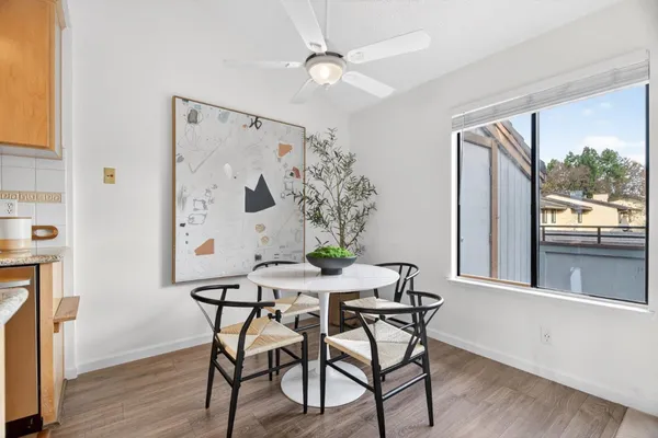 a view of a dining room with furniture window and wooden floor