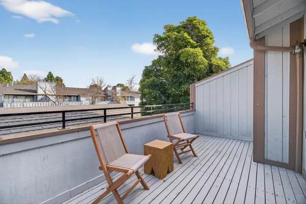 a balcony with wooden floor and fence