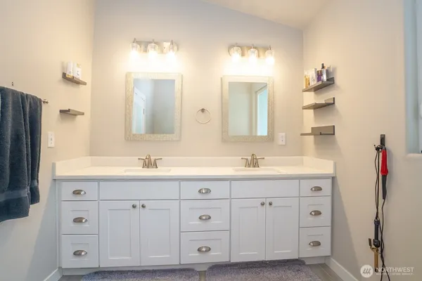 a bathroom with a granite countertop sink double and mirror