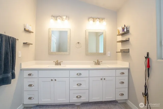 a bathroom with a granite countertop sink double and mirror