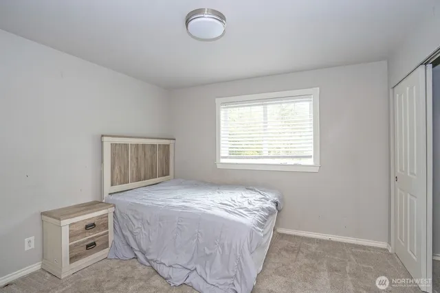a spacious bedroom with a bed and a window