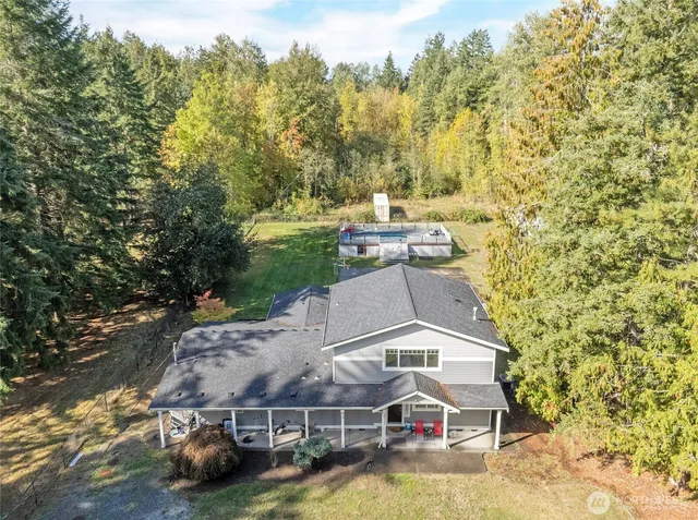 an aerial view of a house with a yard basket ball court and outdoor seating