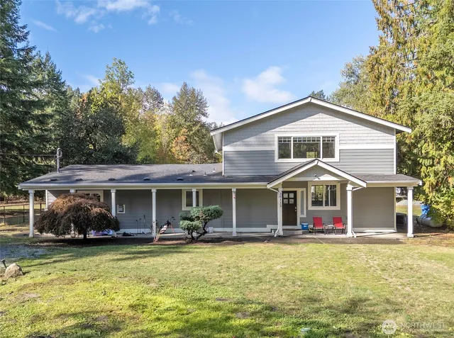 a front view of a house with a yard table and chairs