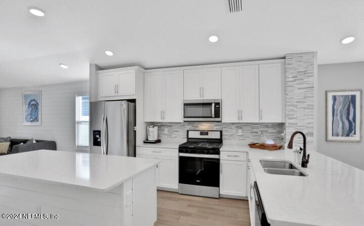 45 Vicksburg Drive St. Johns, FL 32259 - Photo 20 of 39 a kitchen with stainless steel appliances a refrigerator sink and white cabinets