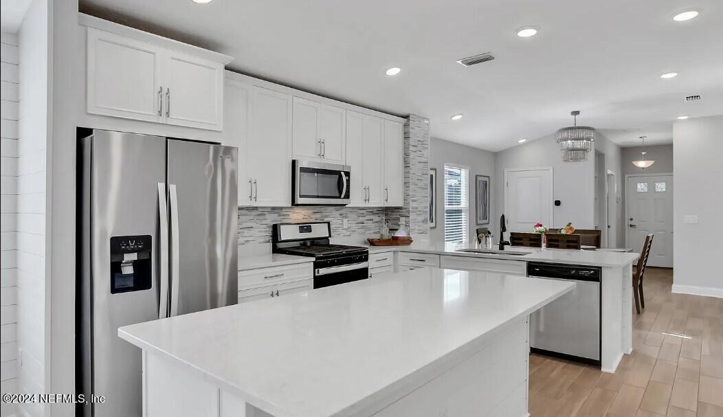 45 Vicksburg Drive St. Johns, FL 32259 - Photo 25 of 39 a kitchen with granite countertop a refrigerator stove top oven and sink