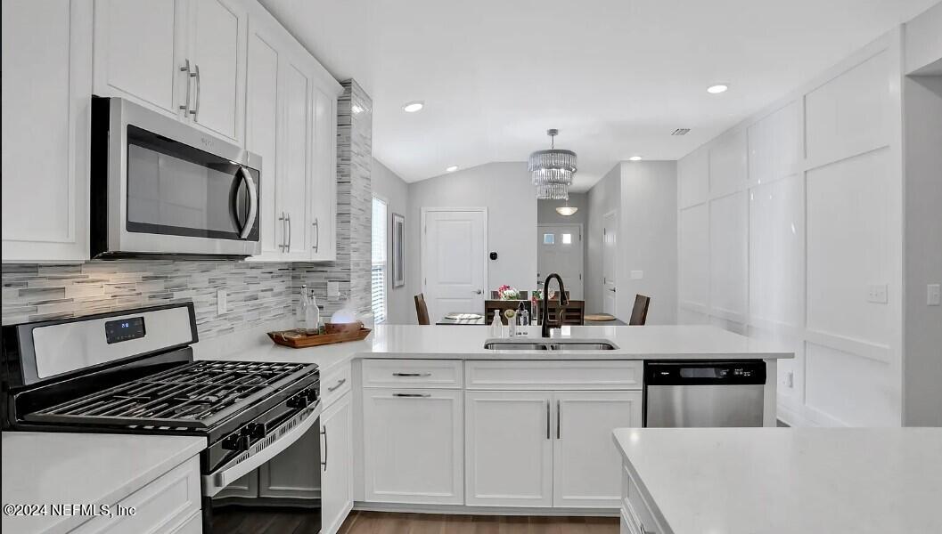 45 Vicksburg Drive St. Johns, FL 32259 - Photo 26 of 39 a kitchen with granite countertop a sink stove and cabinets