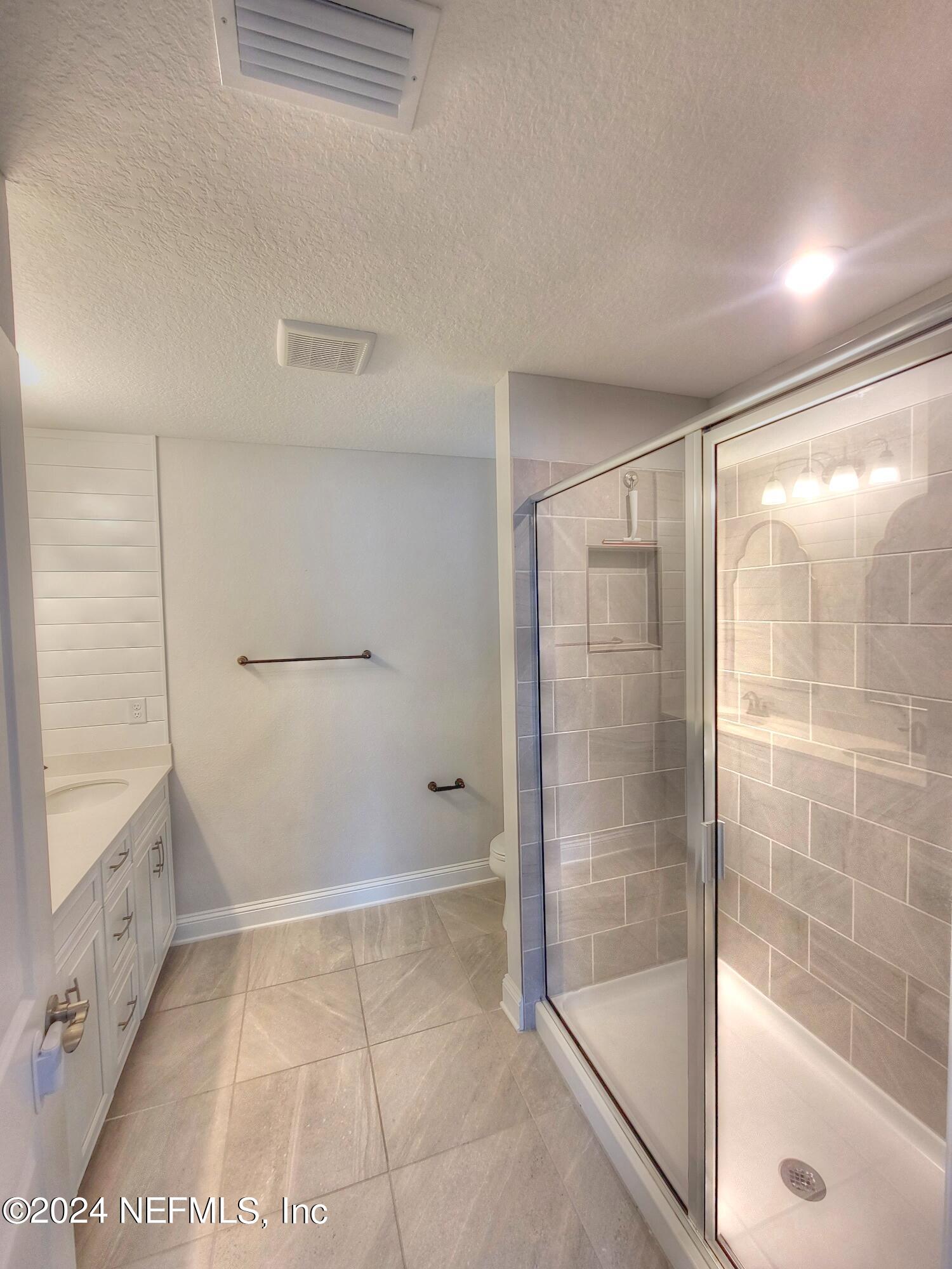 45 Vicksburg Drive St. Johns, FL 32259 - Photo 9 of 39 a bathroom with a glass shower door and a bathtub