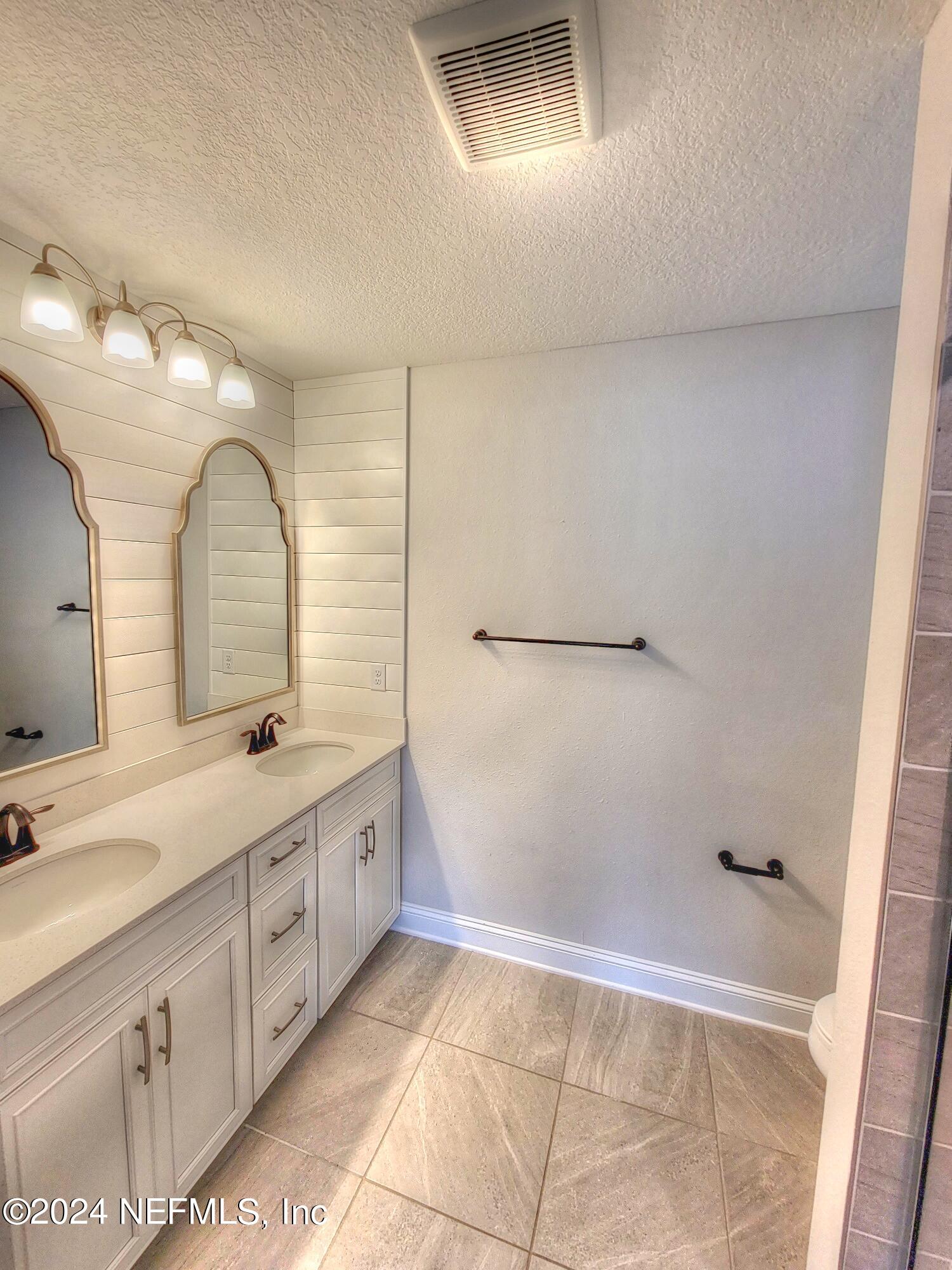 45 Vicksburg Drive St. Johns, FL 32259 - Photo 10 of 39 a bathroom with a double vanity sink and mirror with shower
