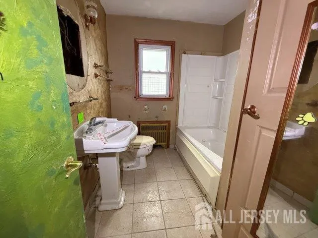 a bathroom with a sink a toilet and bathtub