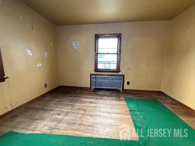 a view of an empty room with a fireplace and a window