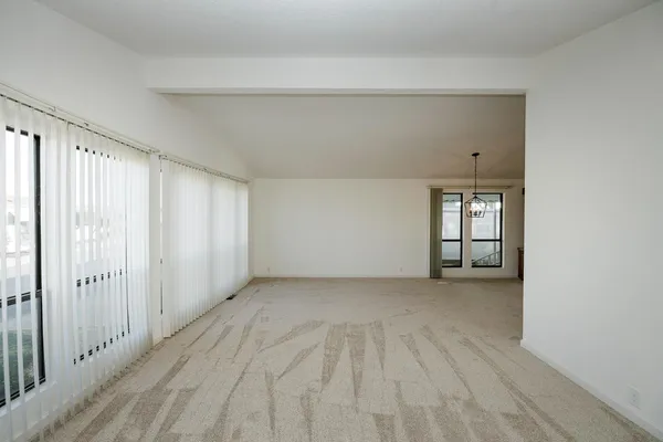 a view of a livingroom with wooden floor and a window