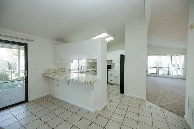 a view of kitchen with furniture and refrigerator
